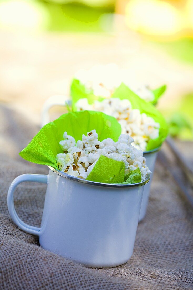 Mugs filled with popcorn