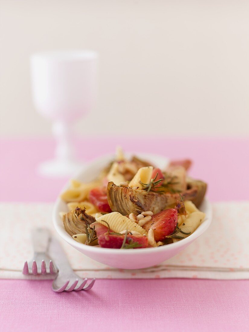 Pasta with fried artichokes, strawberries and pine nuts