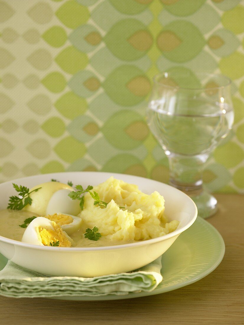 Hard-boiled eggs in mustard sauce with mashed potato