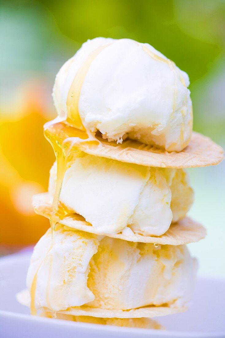 Vanilla ice cream with round wafers and honey