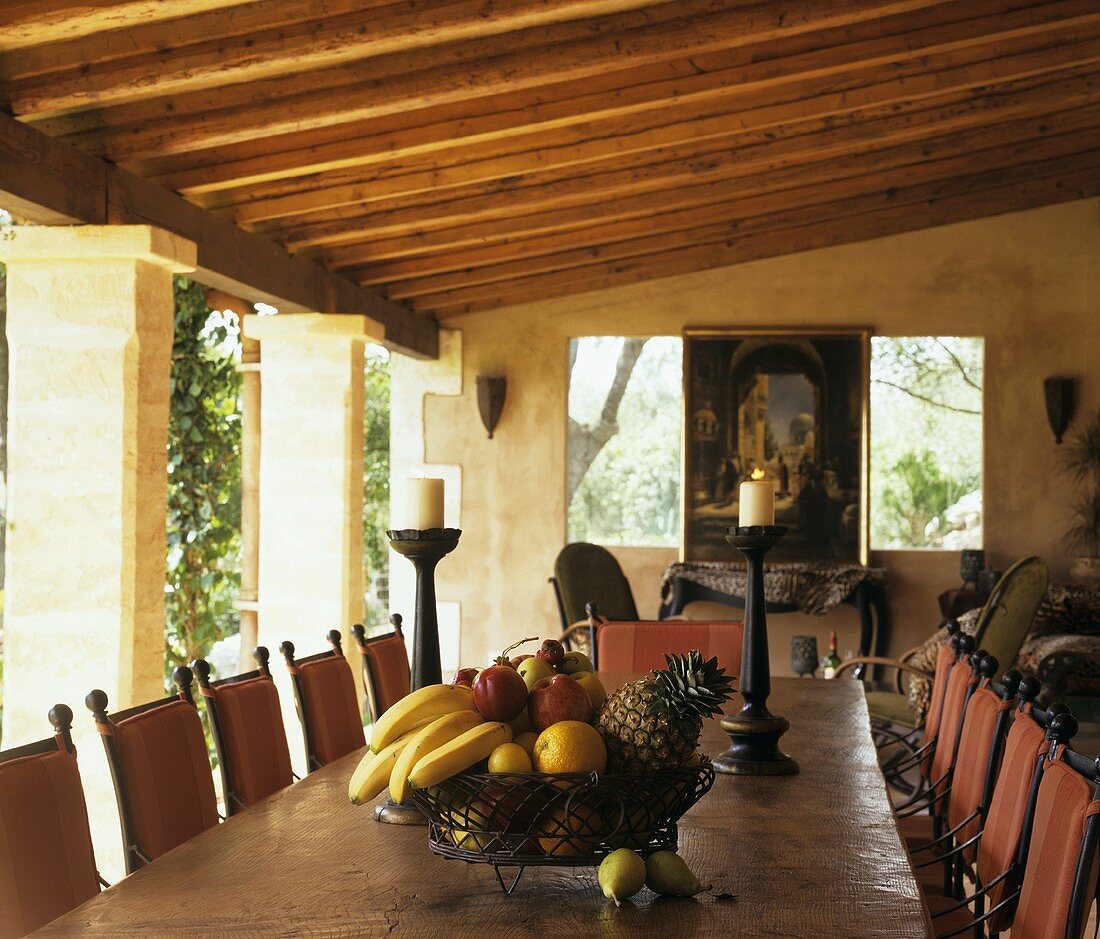 Bowl of fruit on dining table on roofed terrace