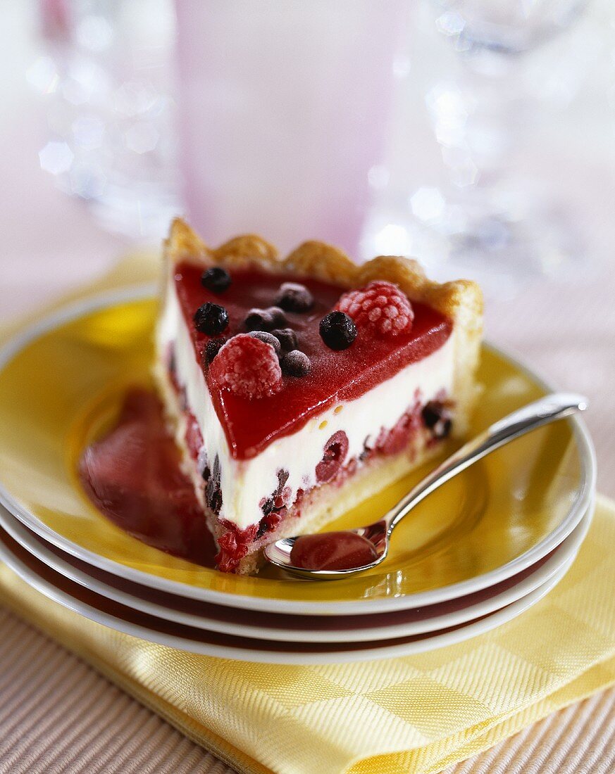 A piece of cheesecake with red berries