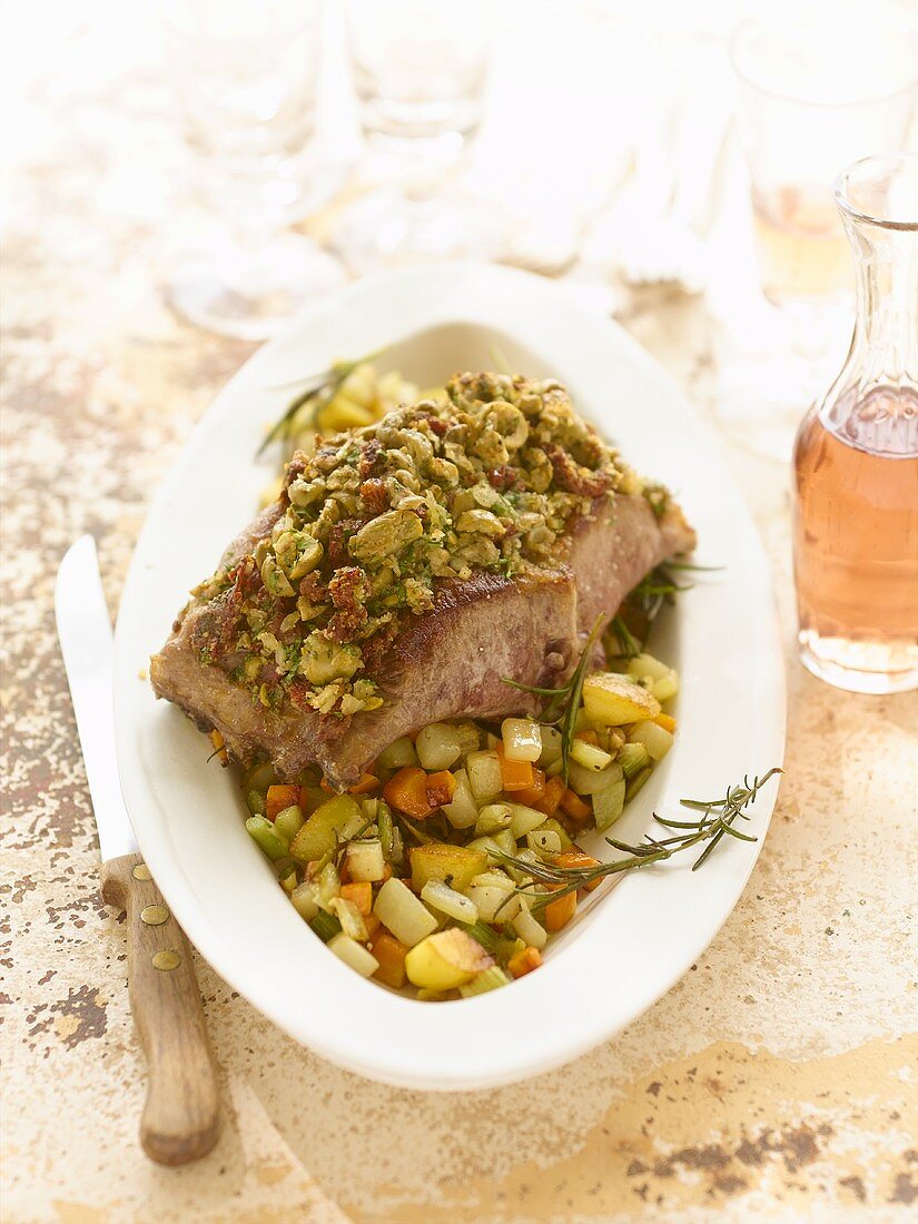 Provençal saddle of lamb with olive crust & rosemary vegetables