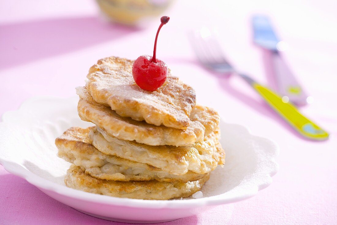 Apple pancakes with a cocktail cherry