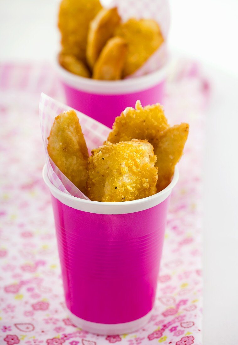 Fish and chips in pink beakers