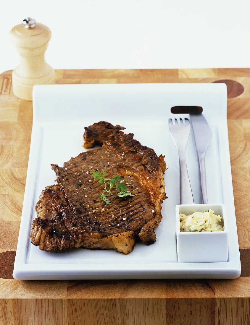 A slice of entrecôte steak with herb butter