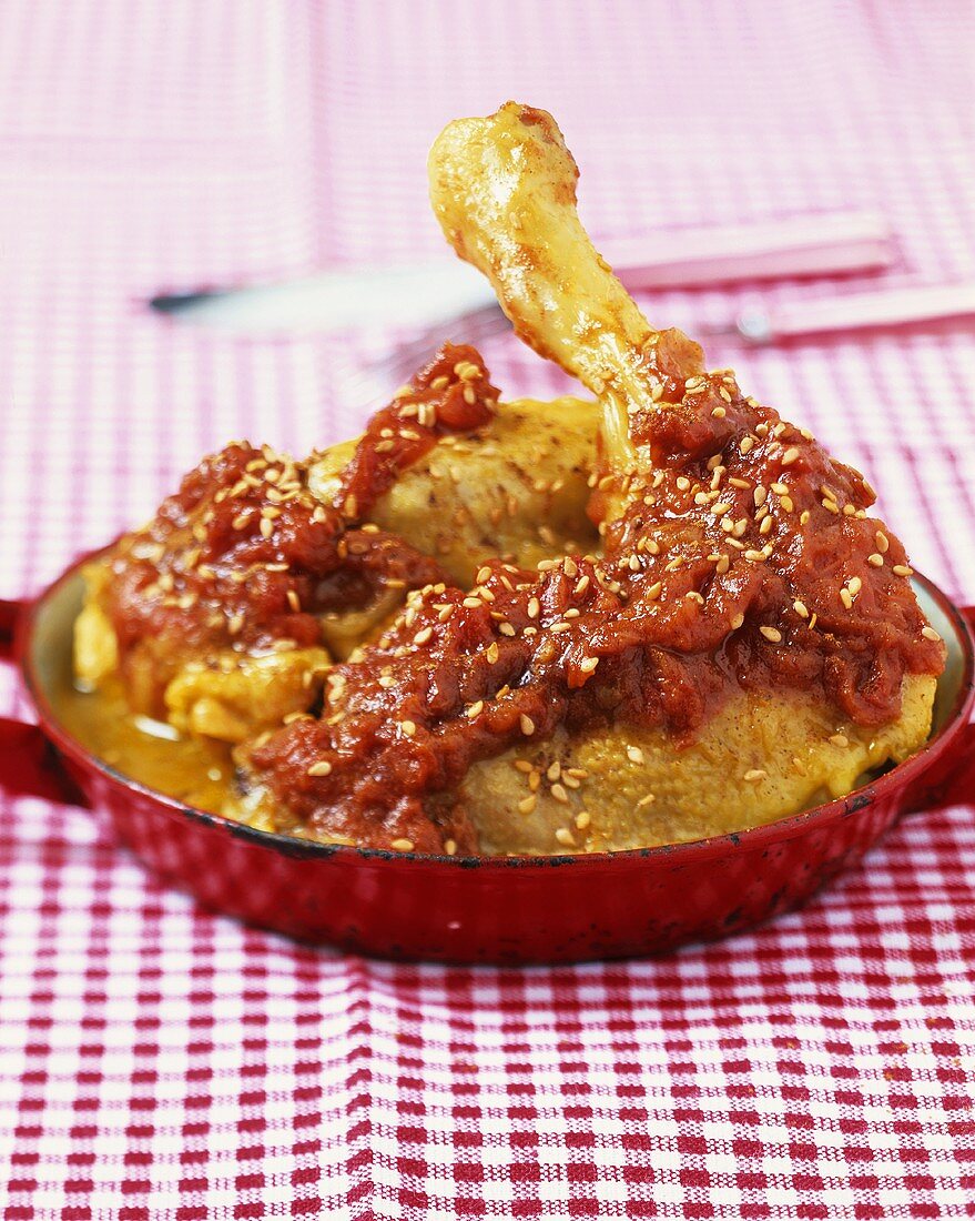 Chicken with tomato sauce and sesame seeds