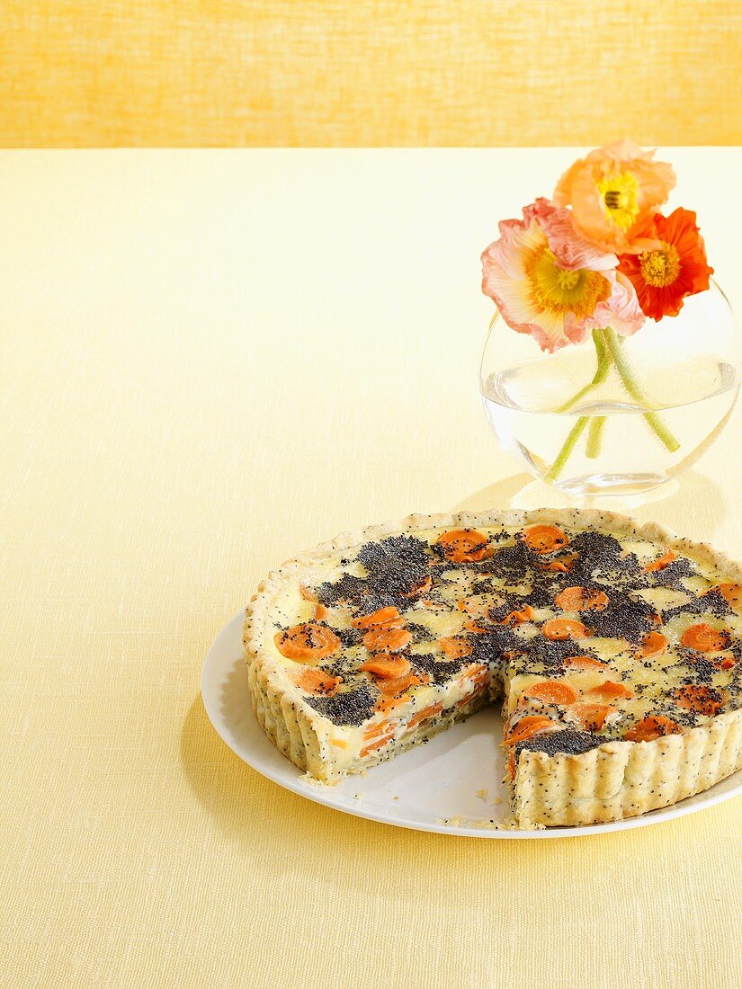 Carrot and poppy seed quiche, a piece removed