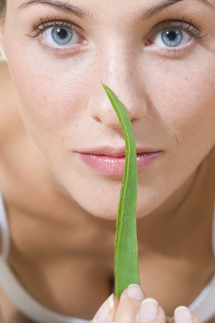 Young woman with Aloe vera