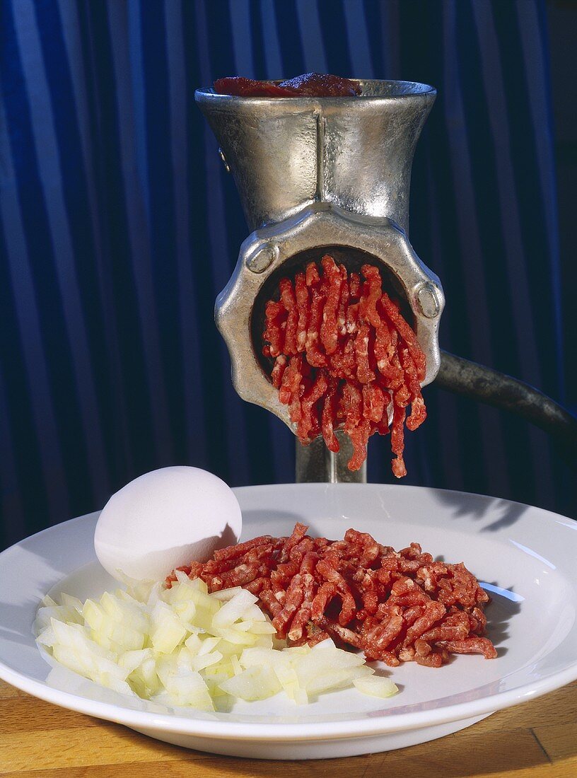 Ingredients for burgers: minced beef, onion and egg