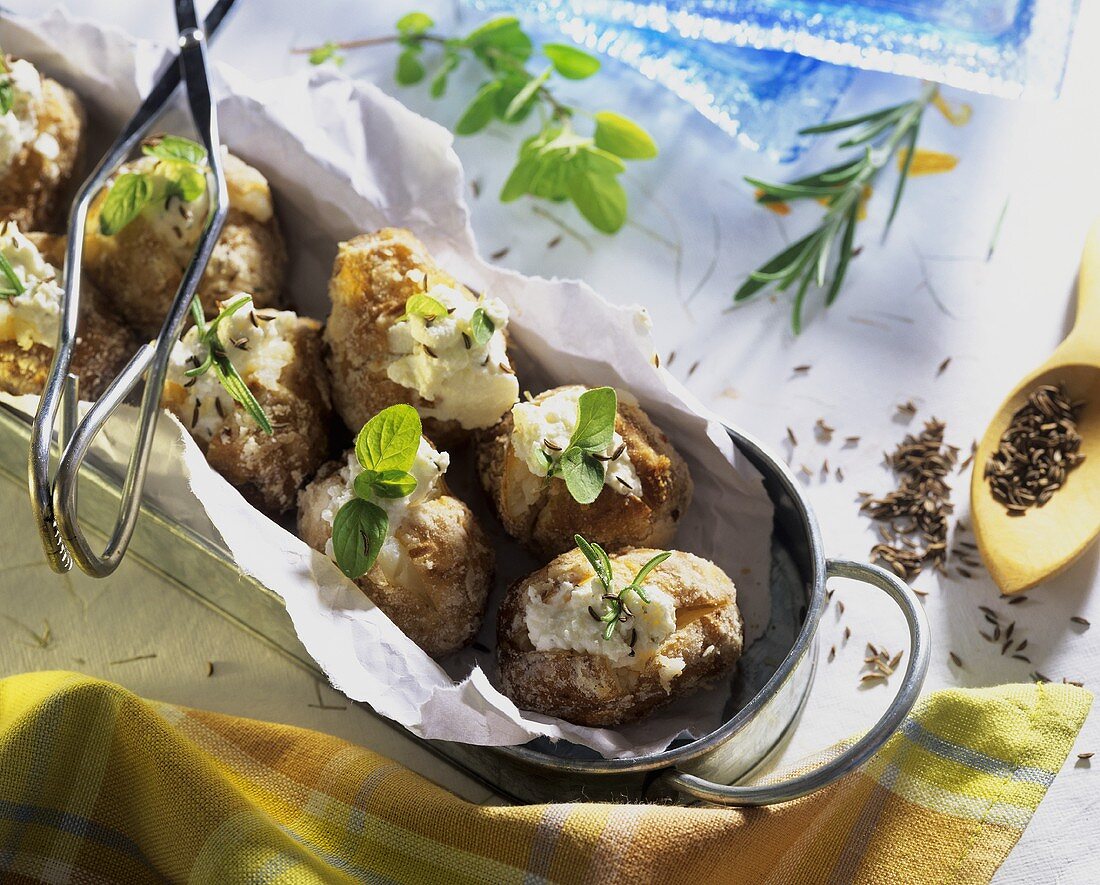 Baked potatoes with sheep's cheese, caraway seeds & herbs