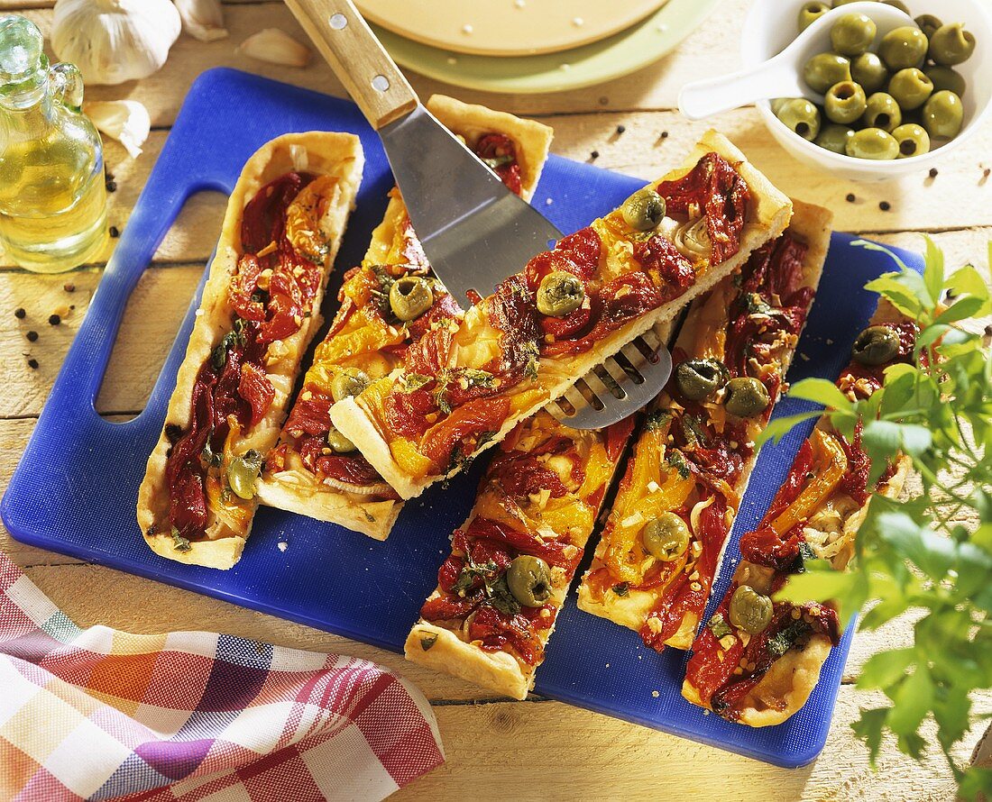 Pizza topped with tomatoes, peppers and olives