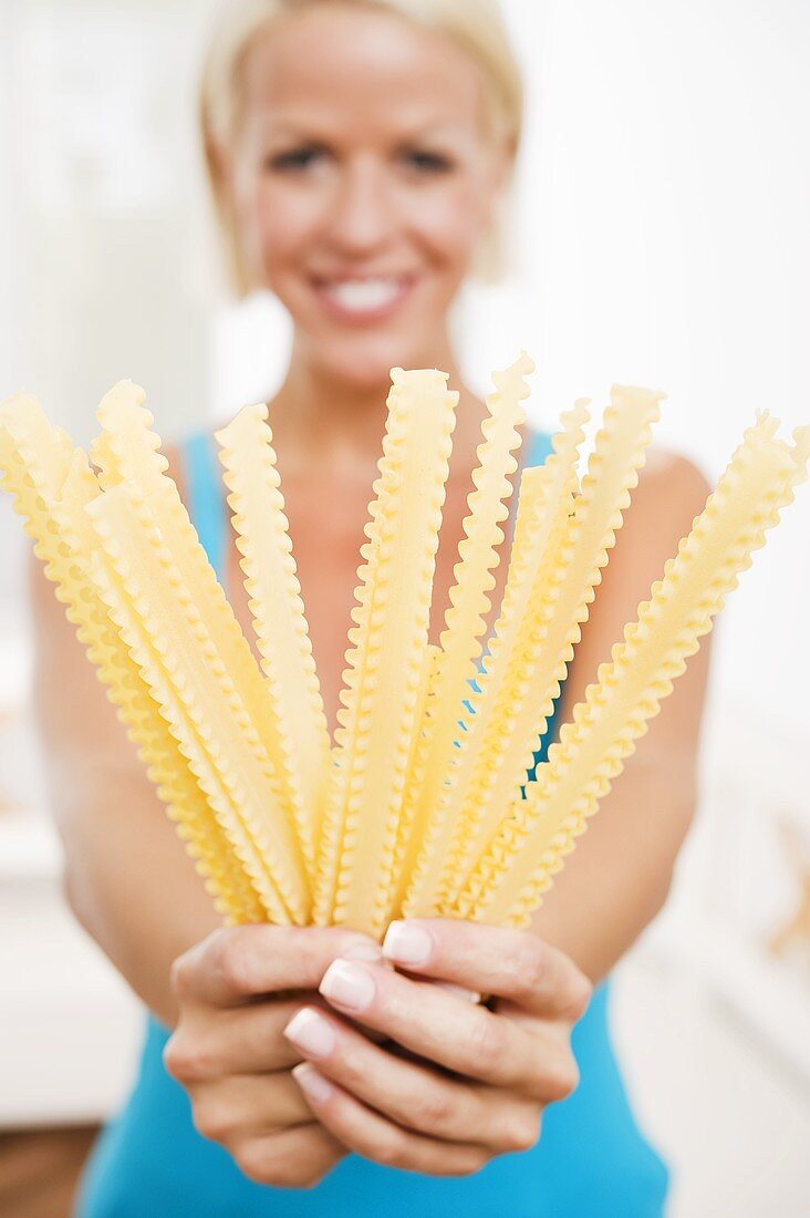 Blond woman with malfadine pasta