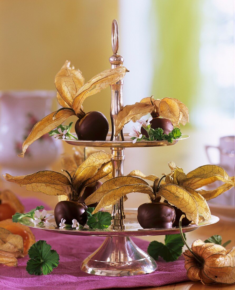 Chocolate-dipped physalis on tiered stand
