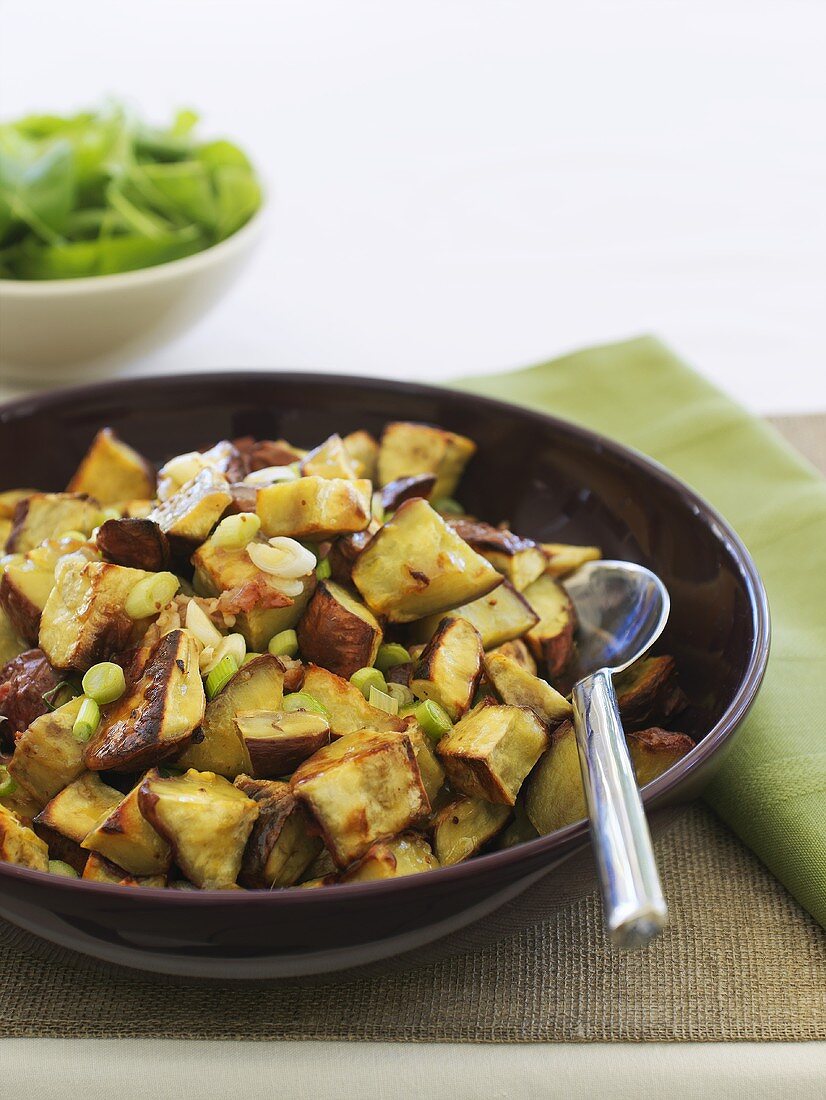 Fried potatoes and spring onions