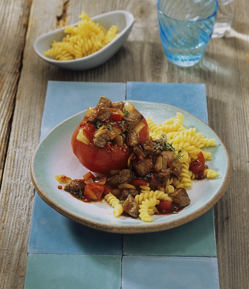 Fiery lamb stew with tomatoes and spiral pasta