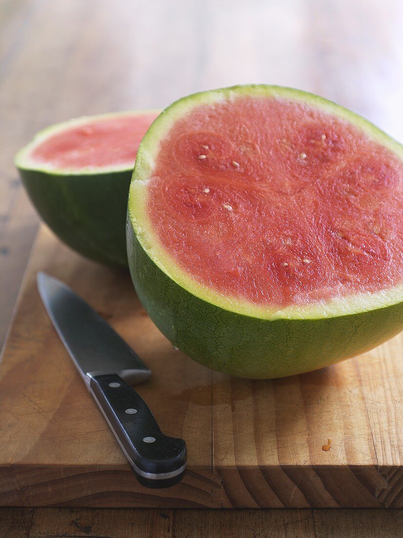 Halved watermelon with knife