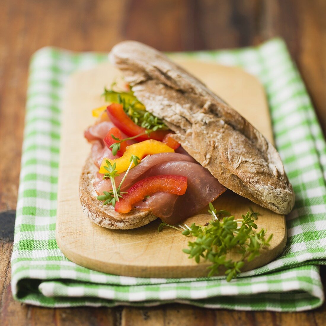 Lachsschinken (cured pork loin) and peppers in rye roll