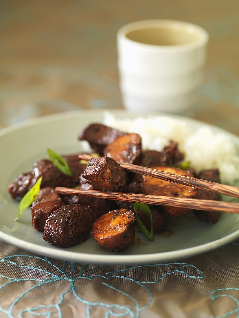 Schweinefleisch mit Champignons und Essstäbchen