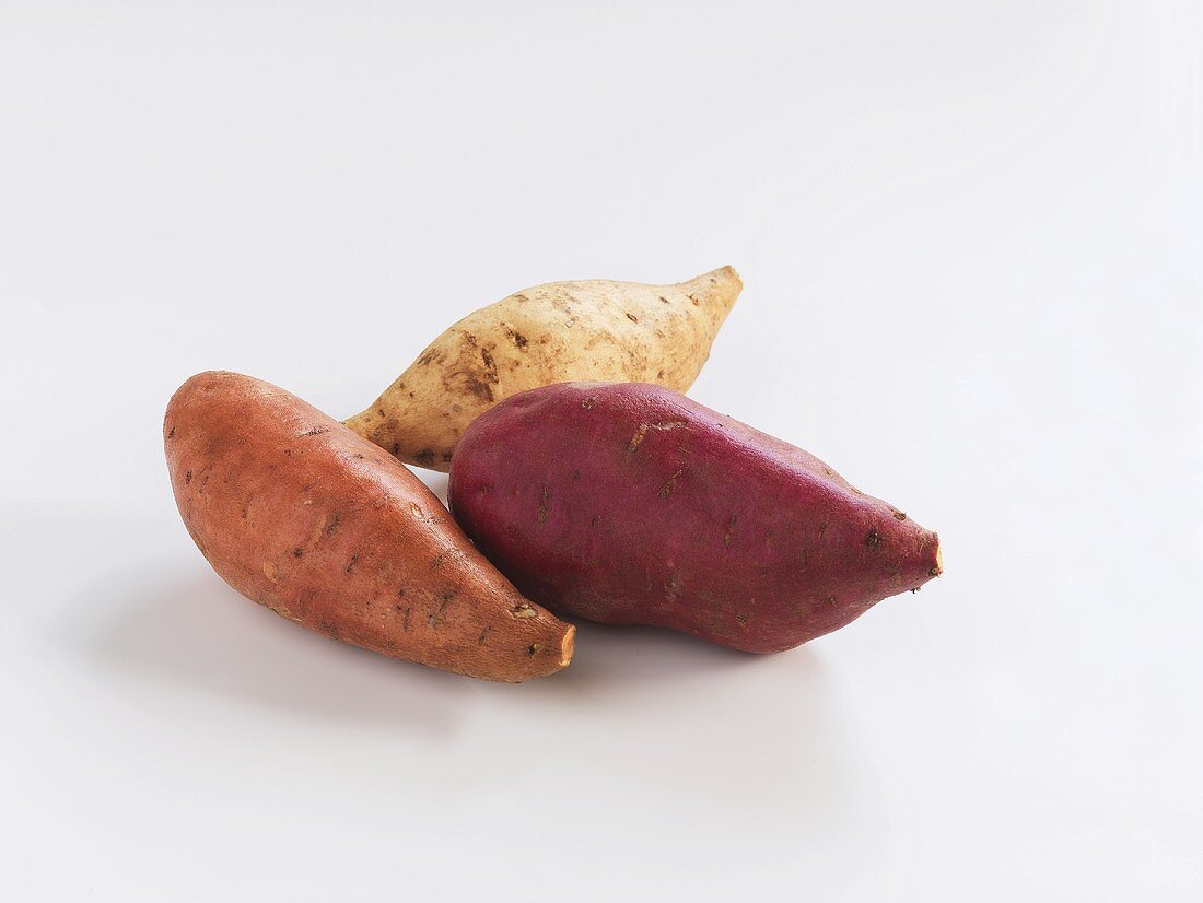 Three sweet potatoes of different varieties