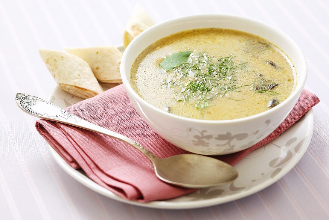 Creamy mushroom soup with dill and pancake rolls