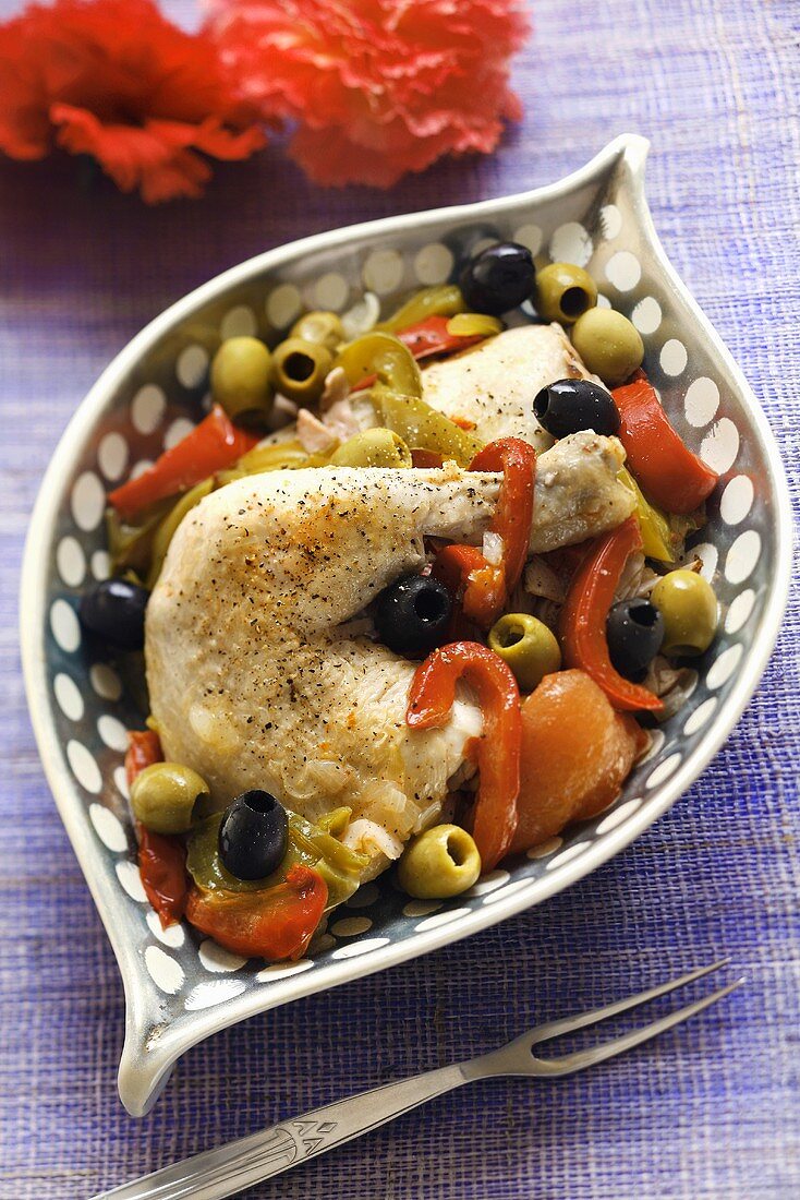 Braised chicken leg with peppers and olives