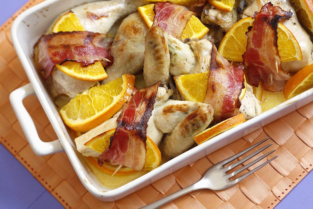 Bacon-wrapped chicken with orange slices