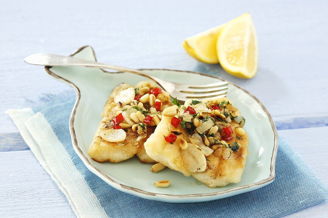 Fish fillet with garlic and pine nuts