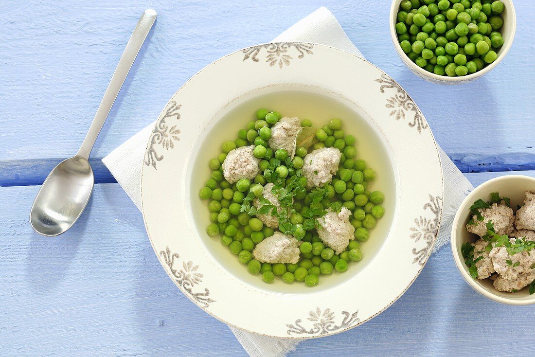 Clear broth with peas and meat dumplings