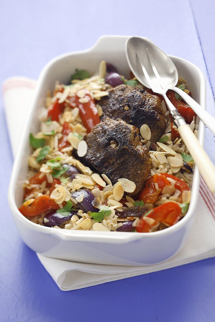 Lamb chops with rice, red peppers and flaked almonds