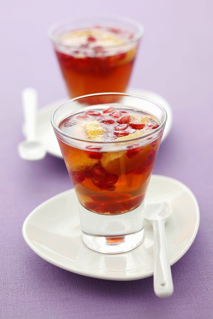 Pomegranate seeds and orange slices in jelly