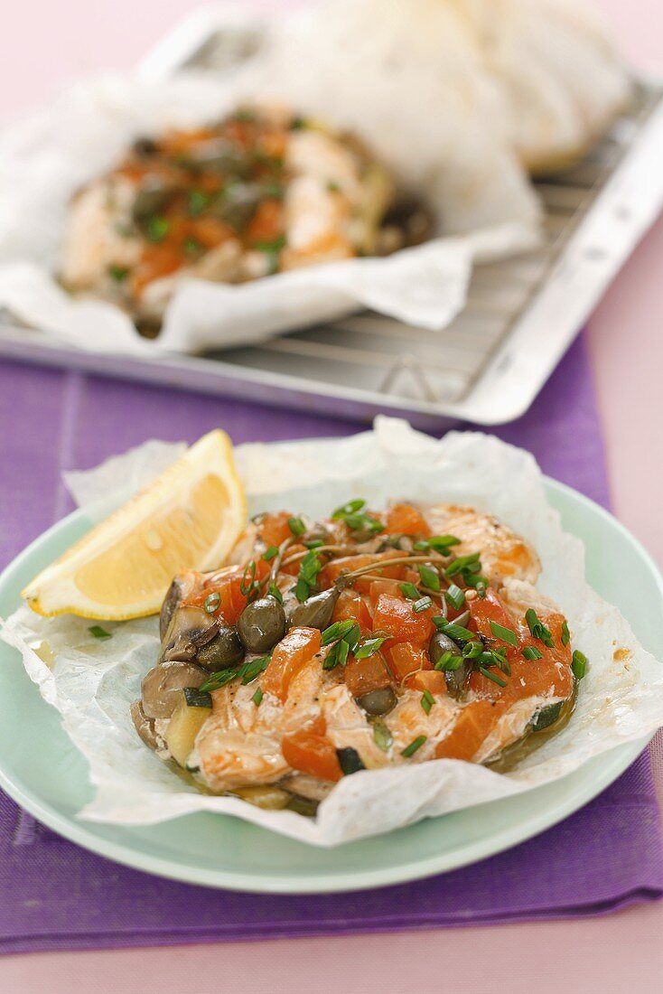 Salmon with capers and tomatoes baked in parchment