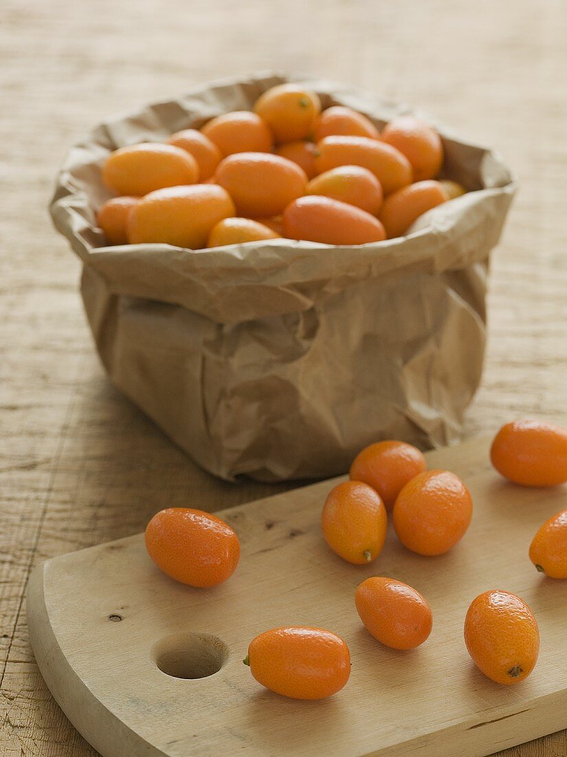 Kumquats in a sack and on a wooden board