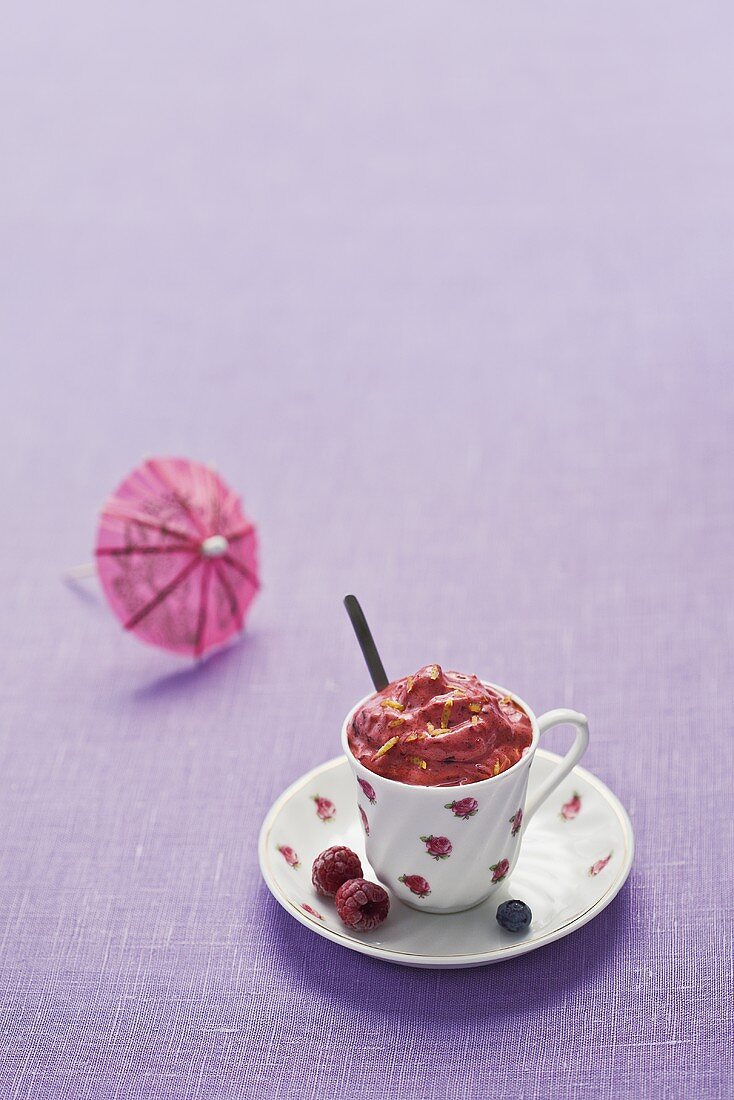 Berry ice cream in a cup, cocktail umbrella