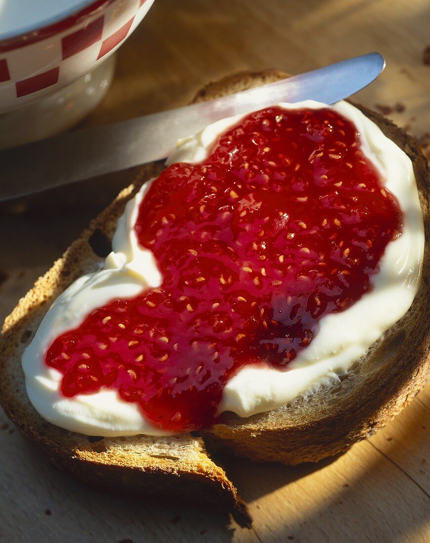 Crème fraîche and raspberry jam on bread