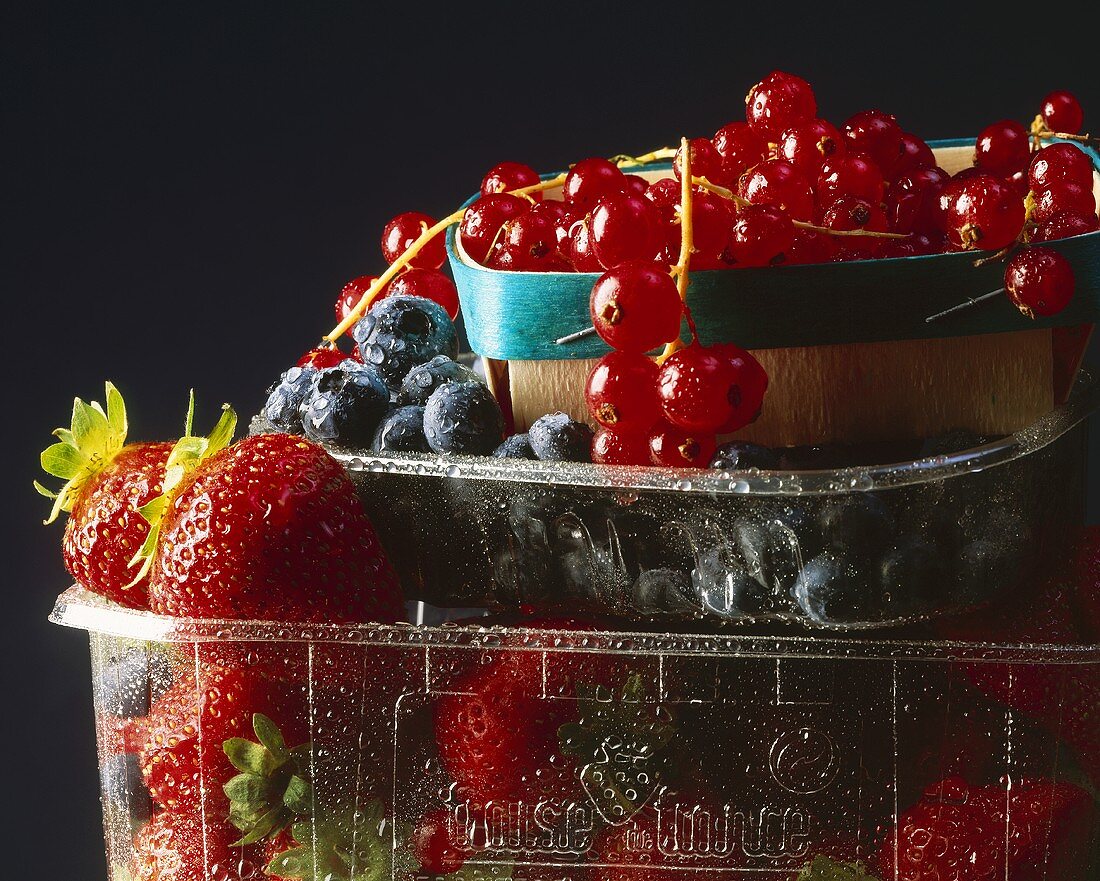 Fresh berries in plastic containers and punnet