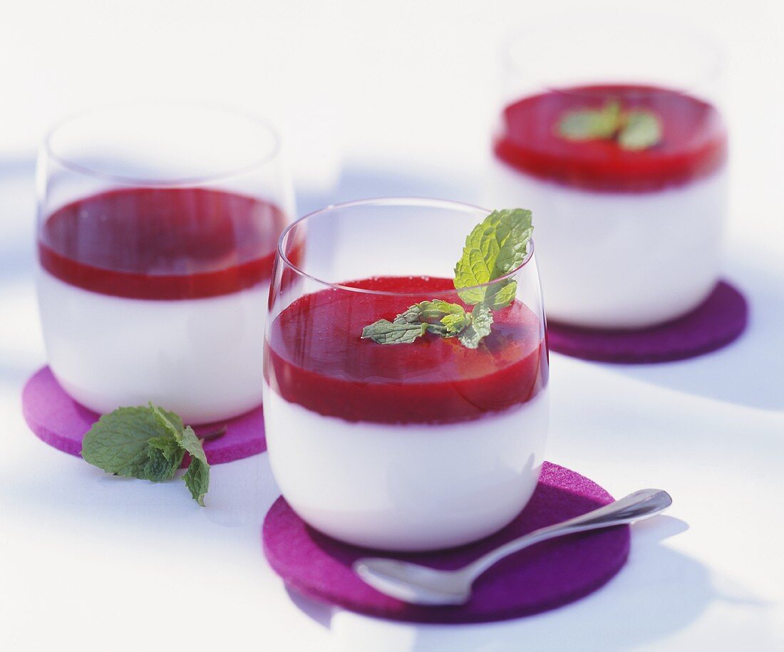 Panna cotta with fruit sauce in glasses