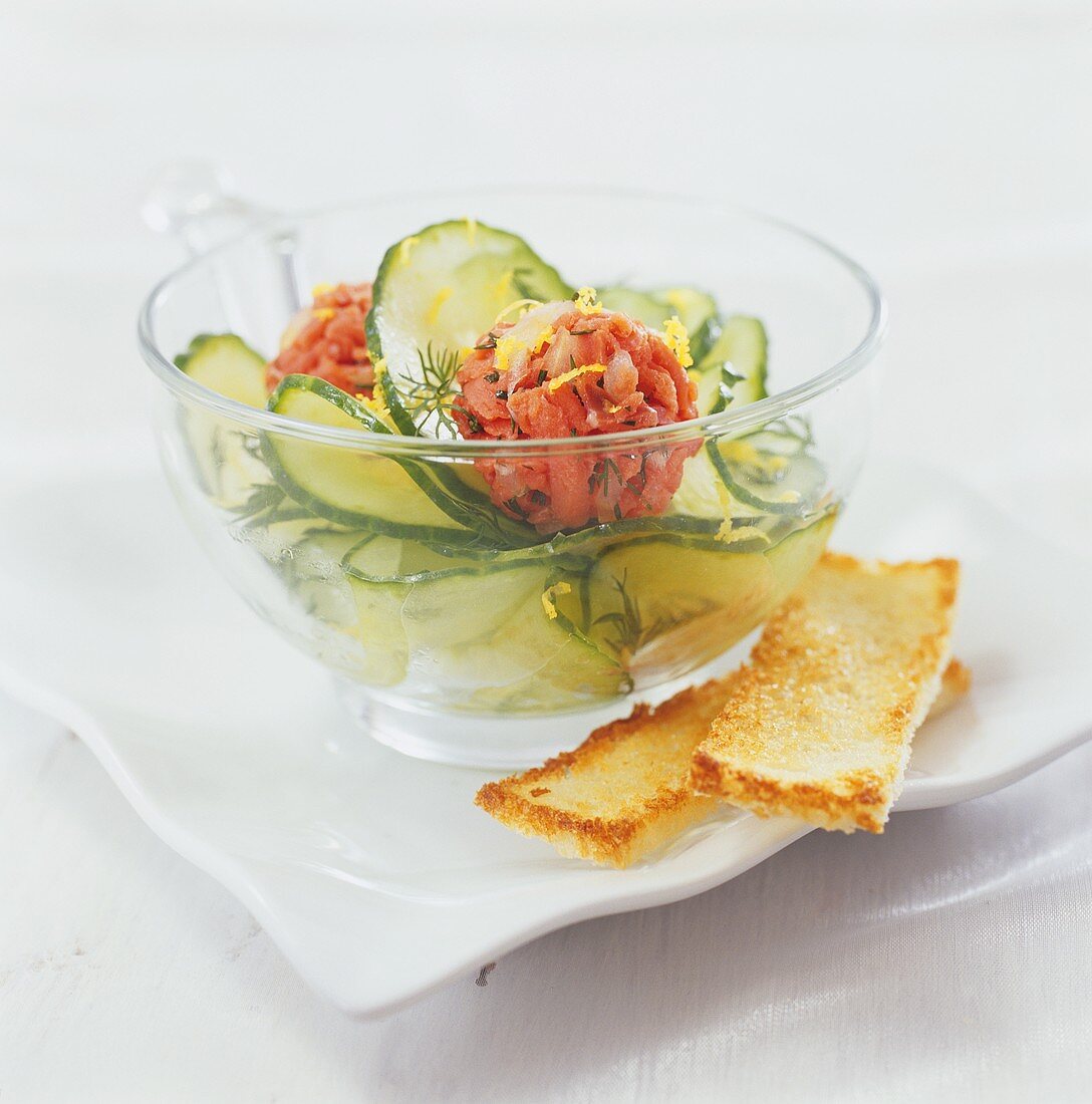 Salmon balls with cucumber salad and fingers of toast