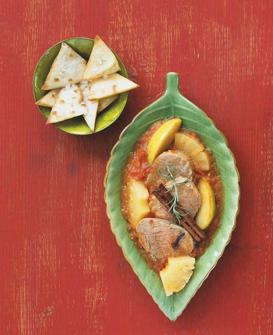 Pork cheeks with tomato sauce, pineapple and apple