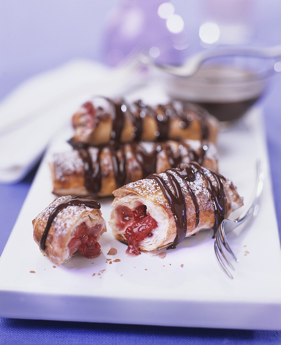 Puff pastries with raspberry filling and chocolate drizzle
