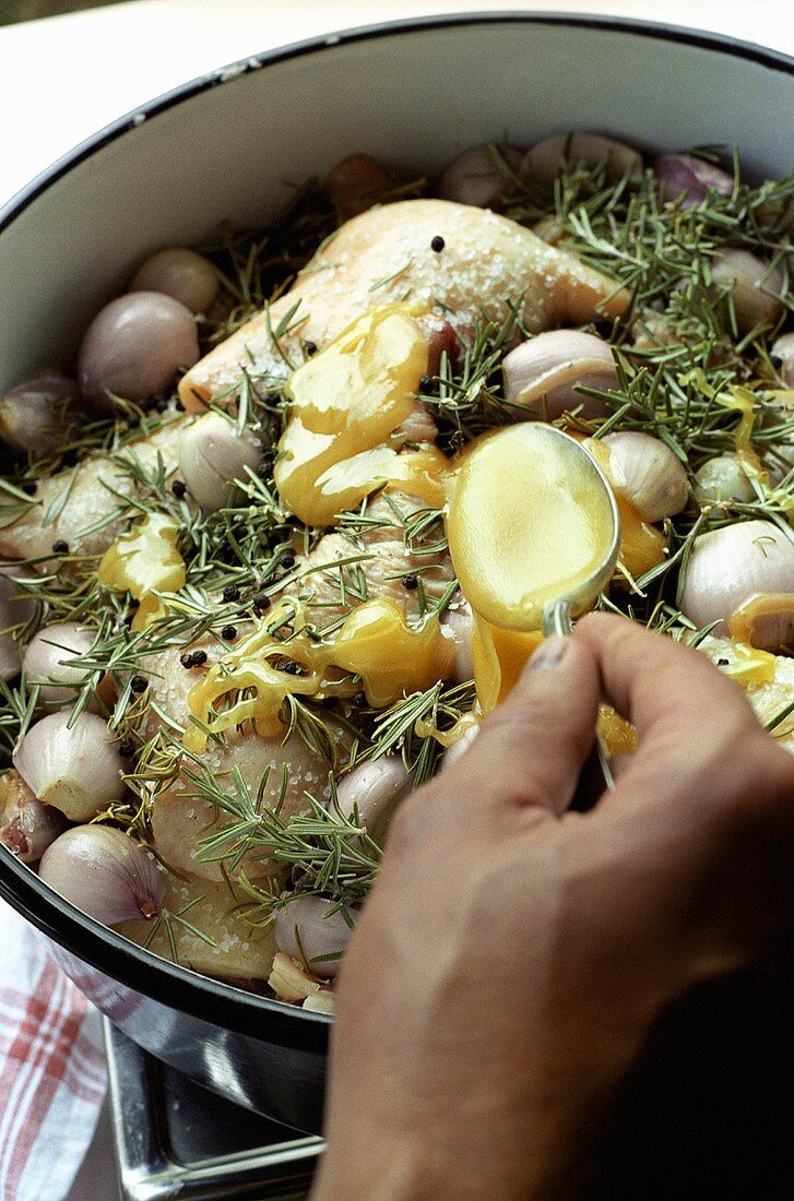 Making duck confit with shallots: marinating in honey