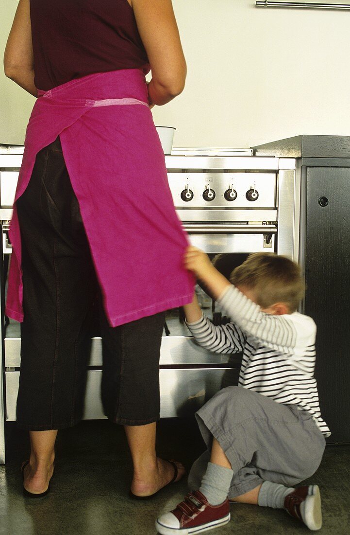 Mother son at stove in kitchen