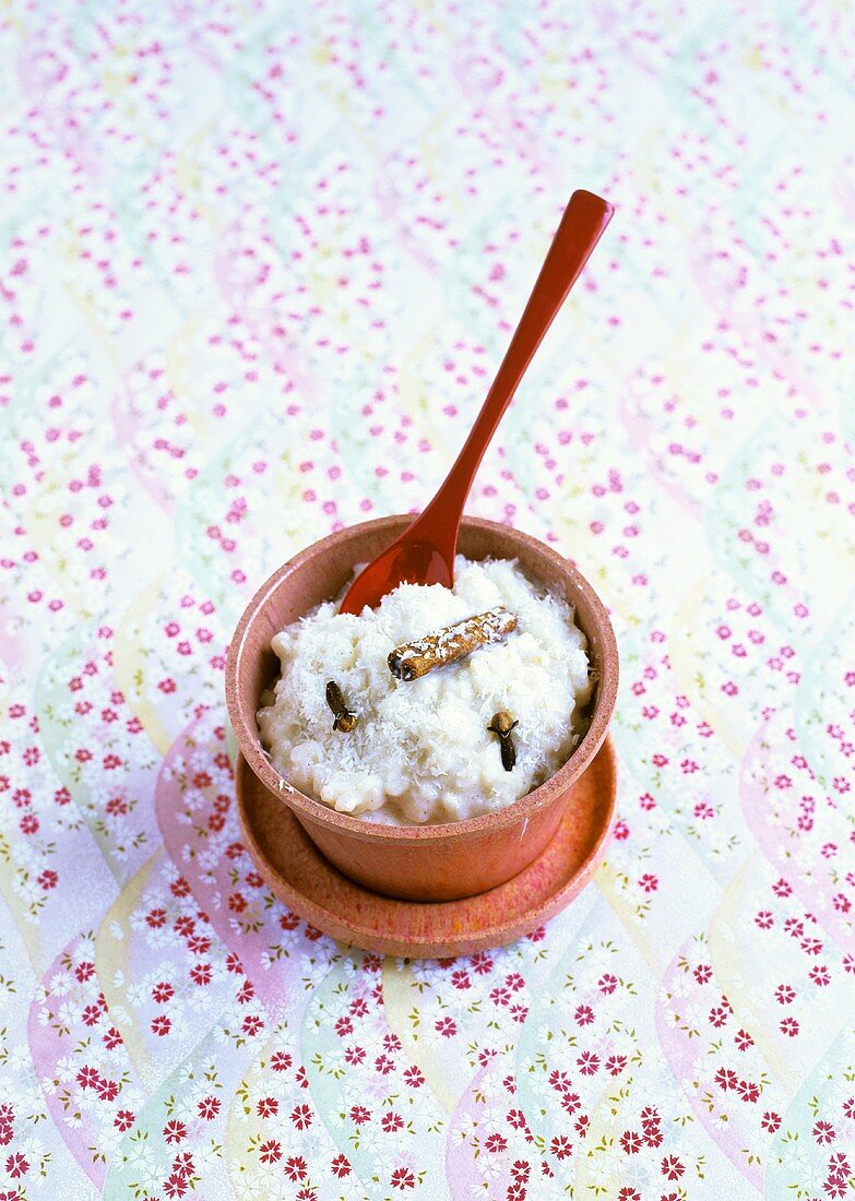 Rice pudding with grated coconut, cloves and cinnamon stick