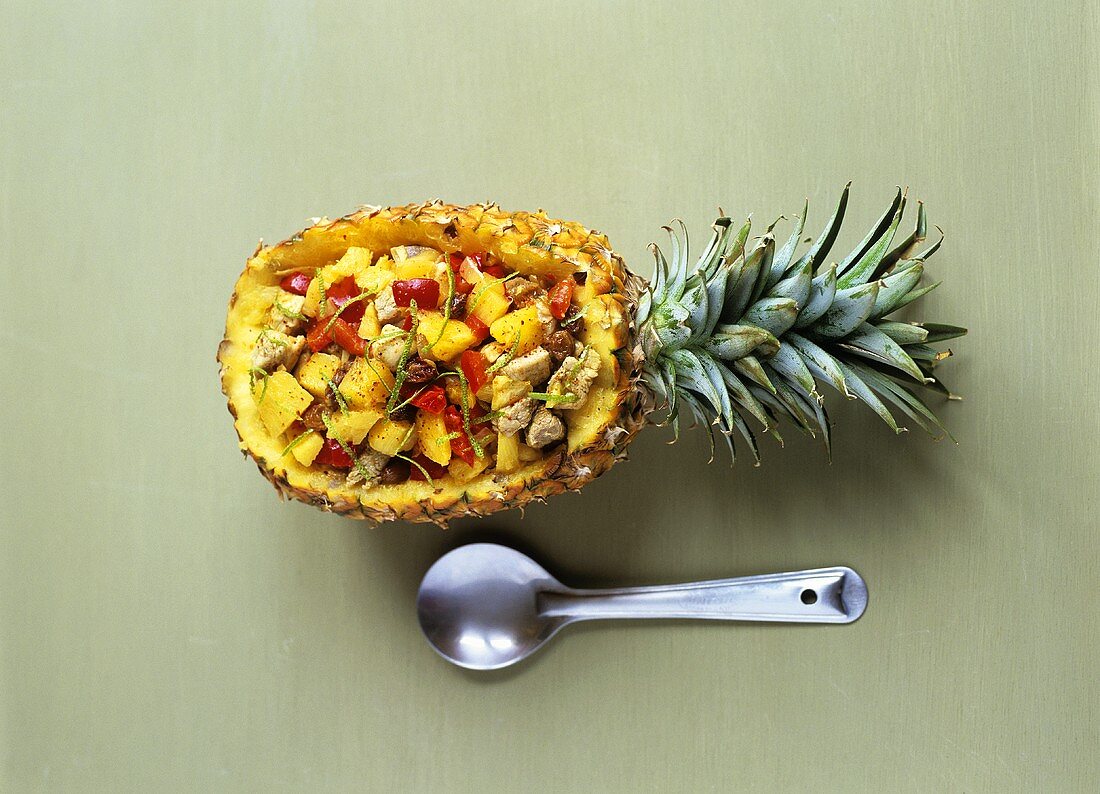 Pork with pineapple and peppers in pineapple half