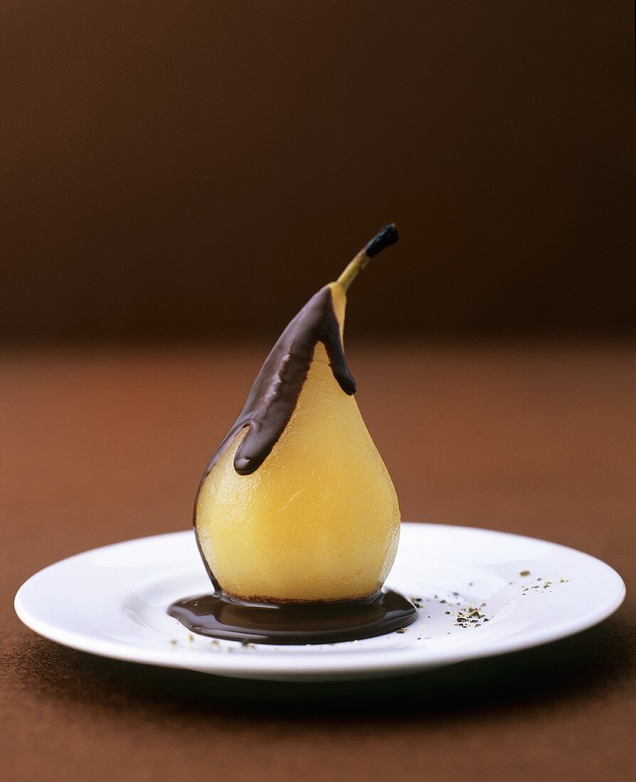 Poached pear with chocolate sauce and pepper