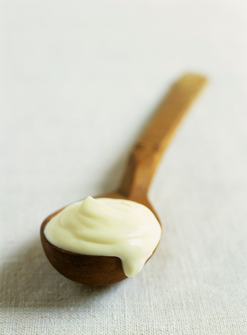 Cream on wooden spoon