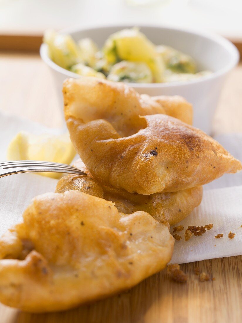 Fish in batter with potato and kale salad