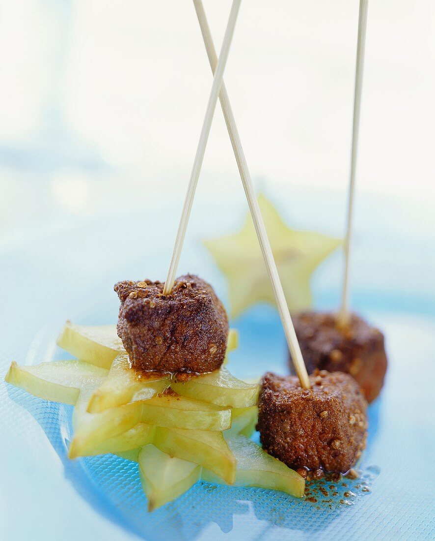 Spicy beef skewers on carambola