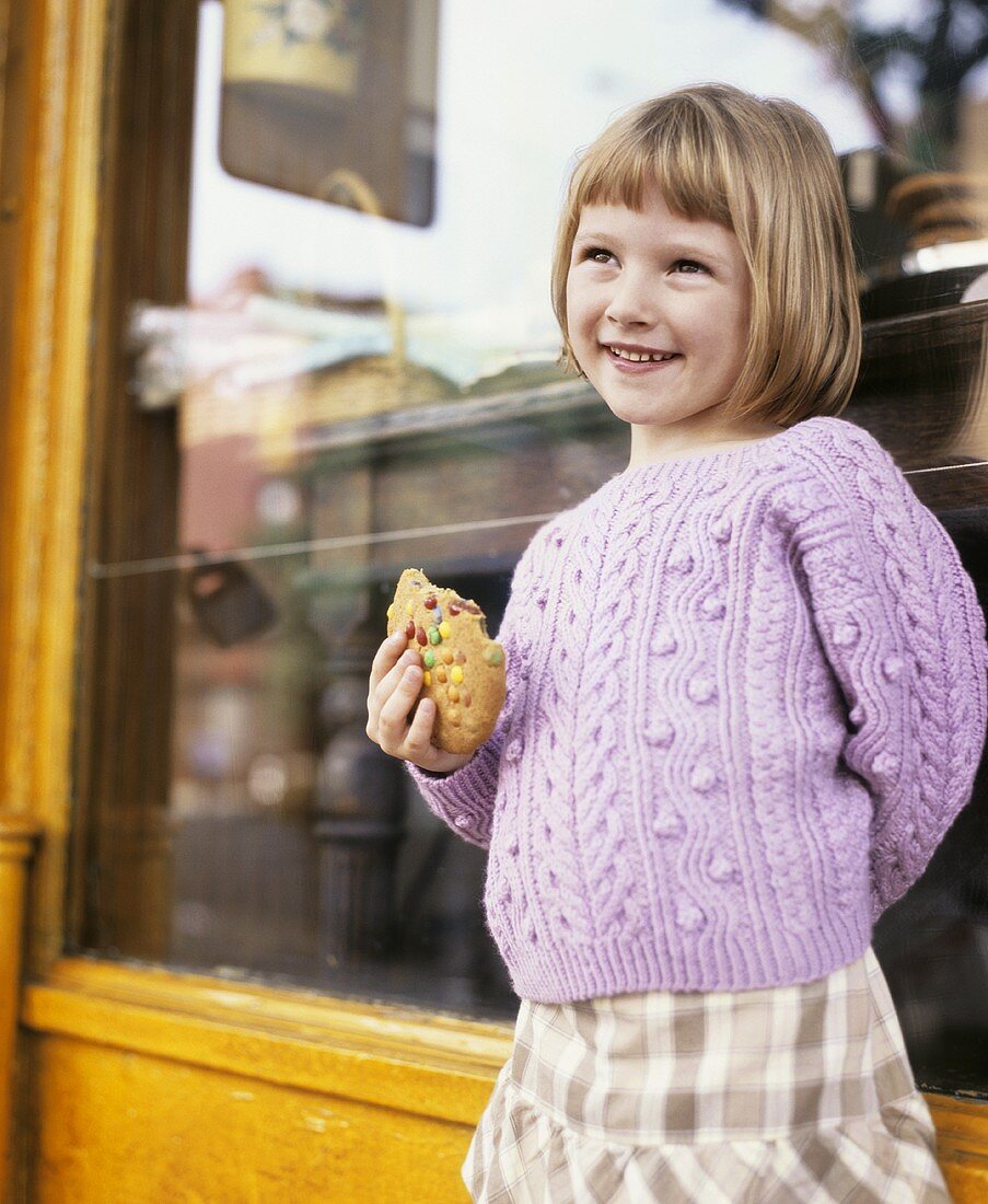 Girl with a biscuit in her hand