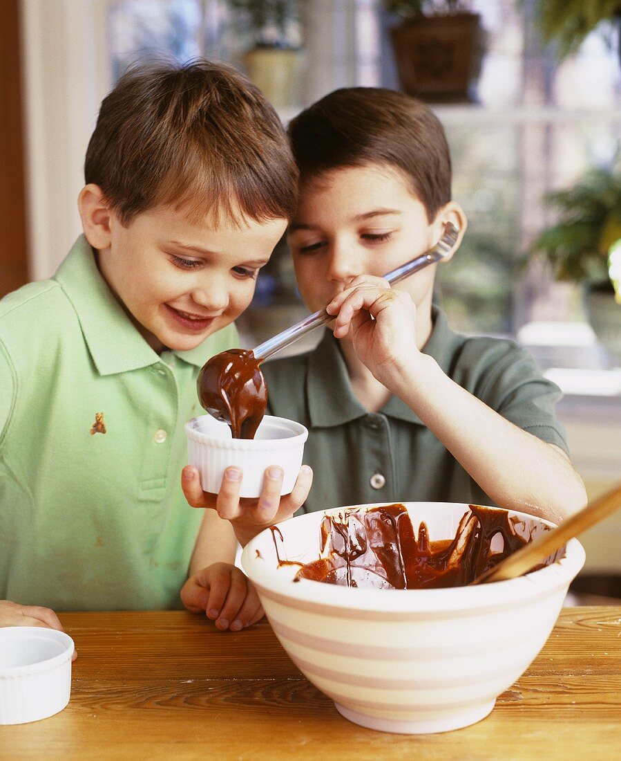 Two boys making chocolate soufflé together